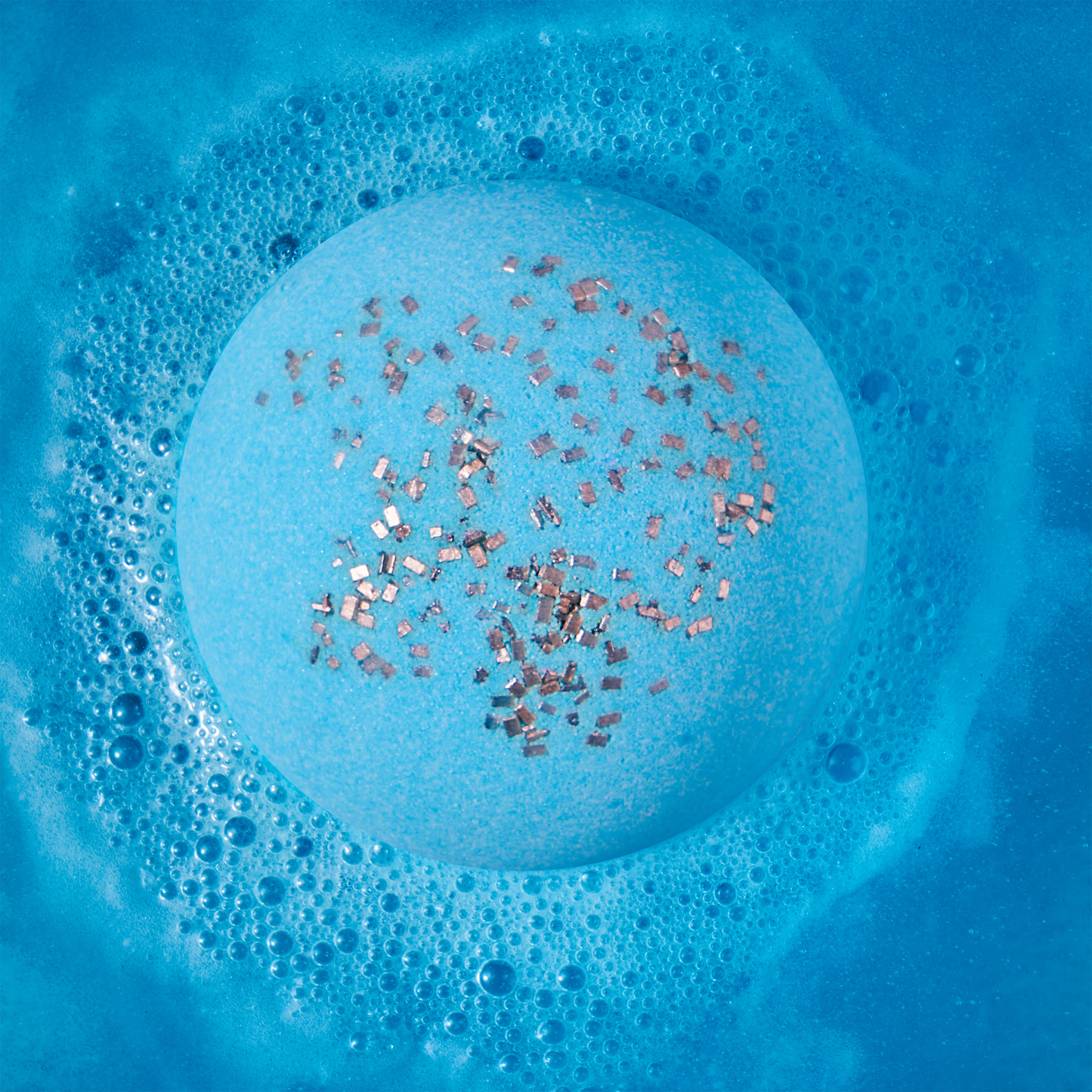a blue bath bomb fizzing in water
