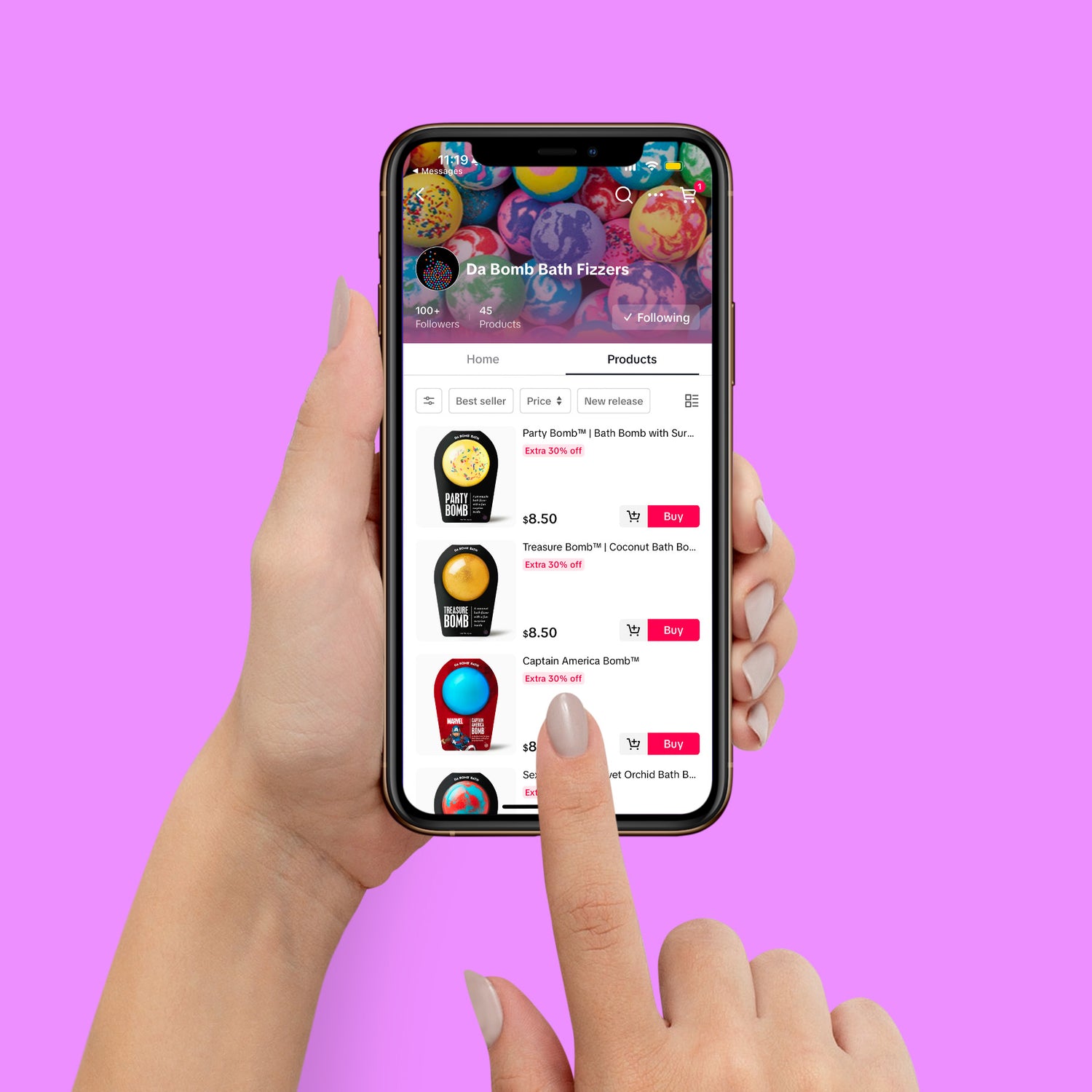 ladies hand holding phone with the da bomb tik tok shop in the screen