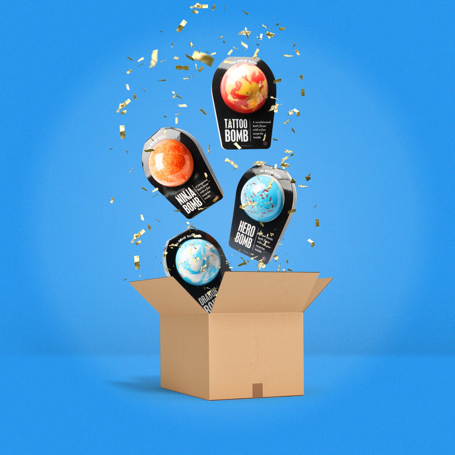 Pink, red, blue, and pink bath bombs in black packaging falling into a cardboard box on a blue background with yellow confetti
