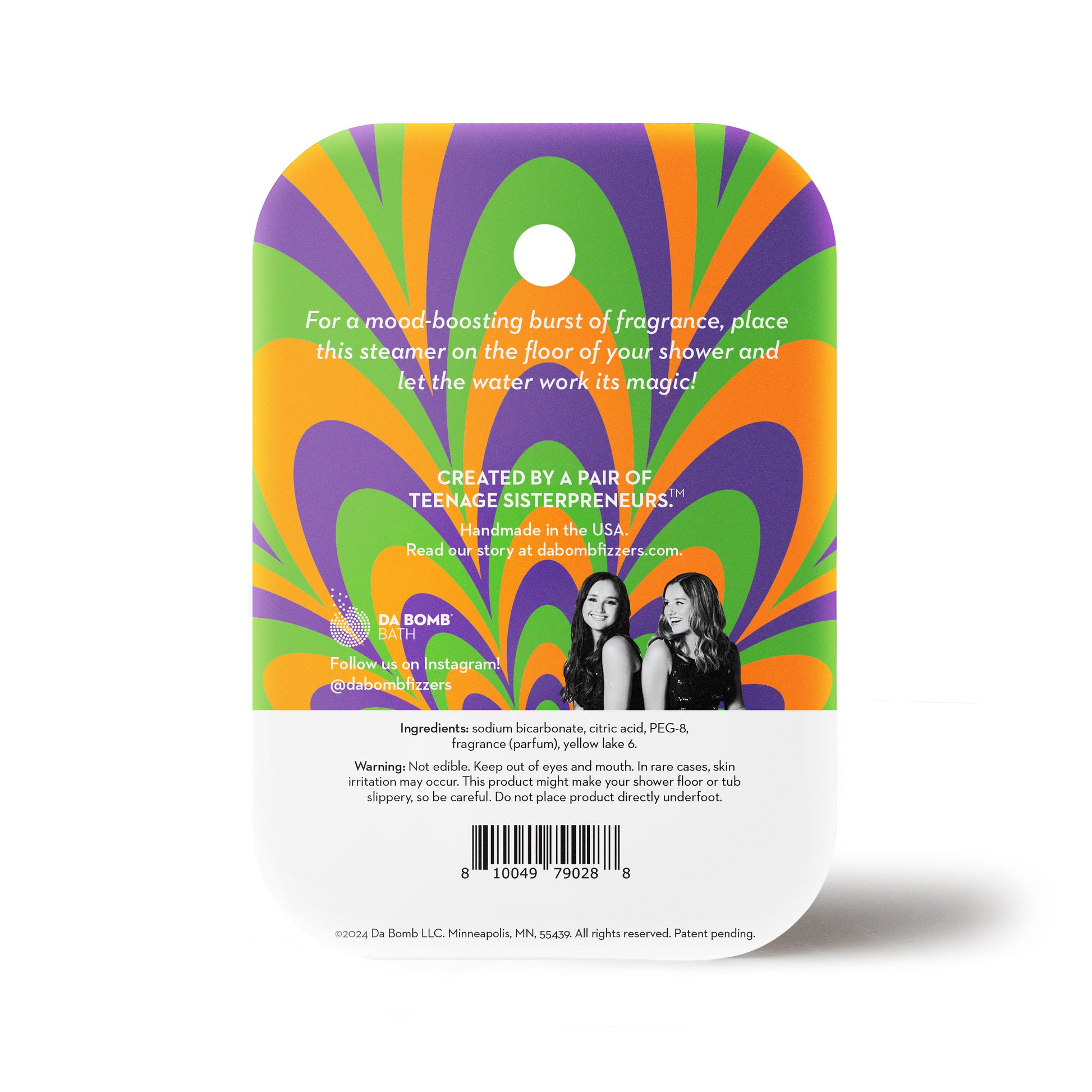 back of an orange shower steamer in green, purple and orange packaging