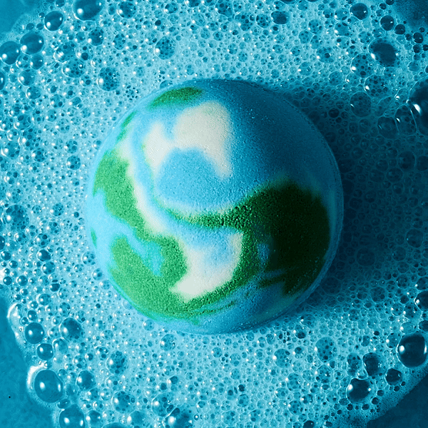gif of blue, green & white earth bath bomb fizzing in water
