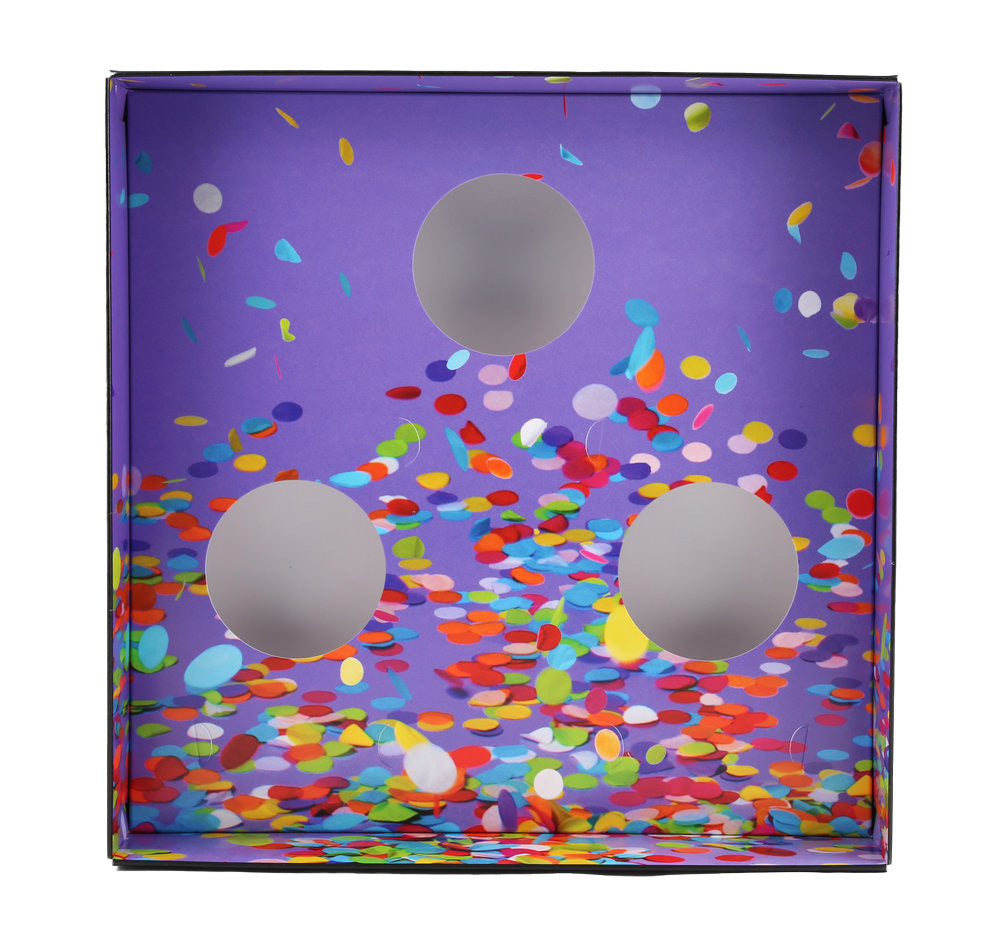 Box with three circular cut-outs on a printed birthday background