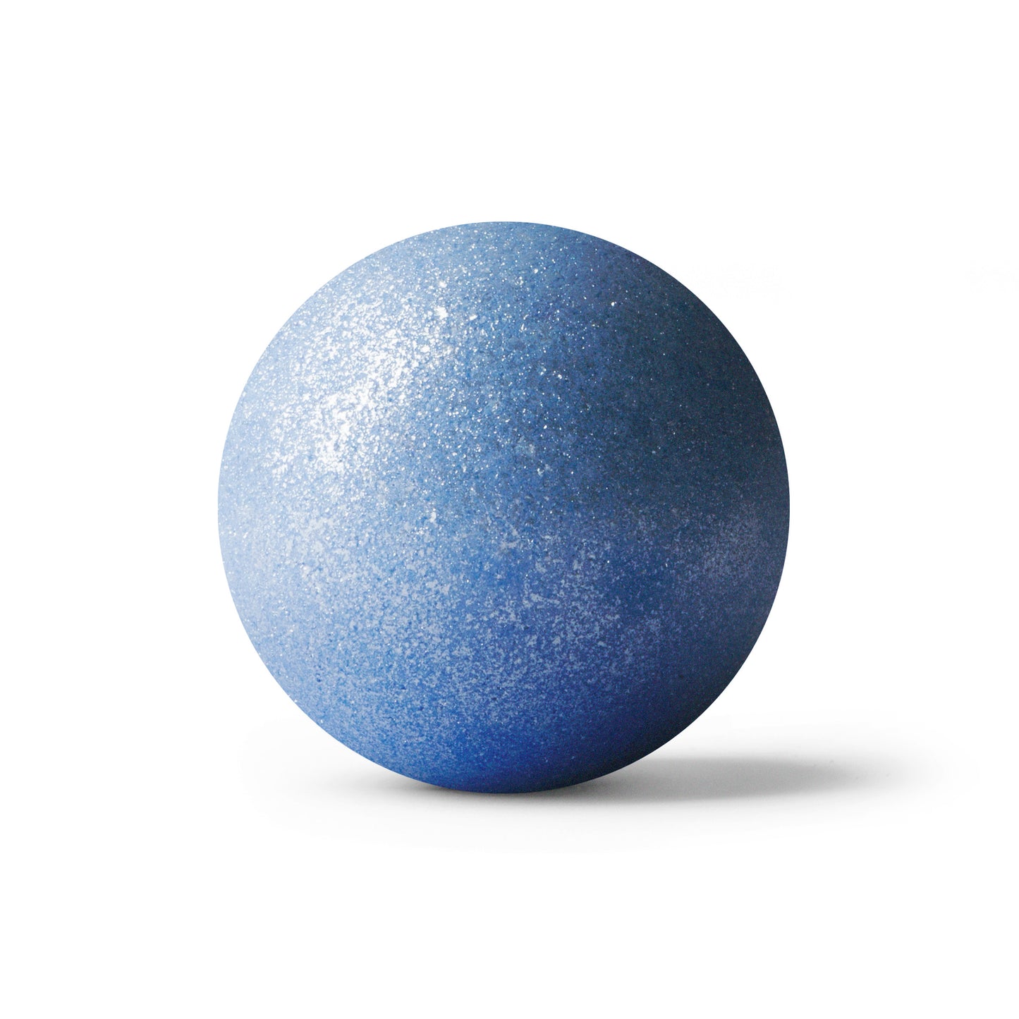 Blue round bath bomb out of packaging on white background.