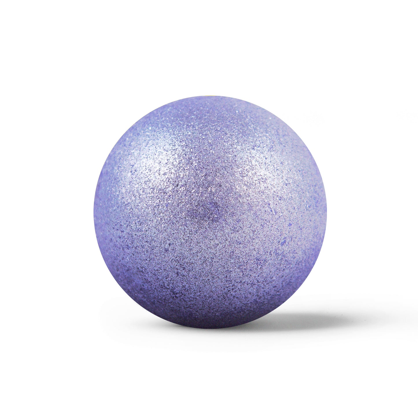 Sparkly purple round bath bomb out of packaging on white background.
