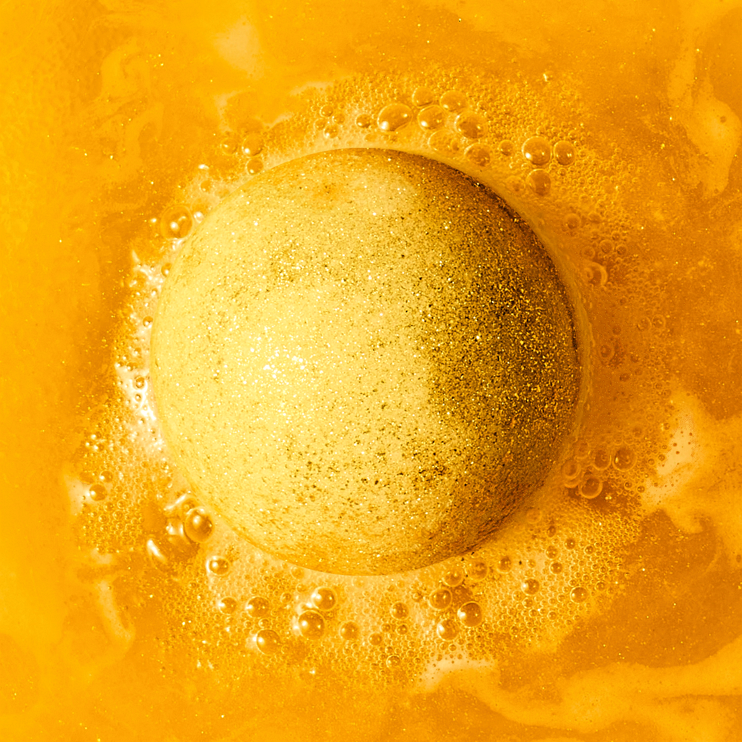 animated gif of gold bath bomb fizzing in water