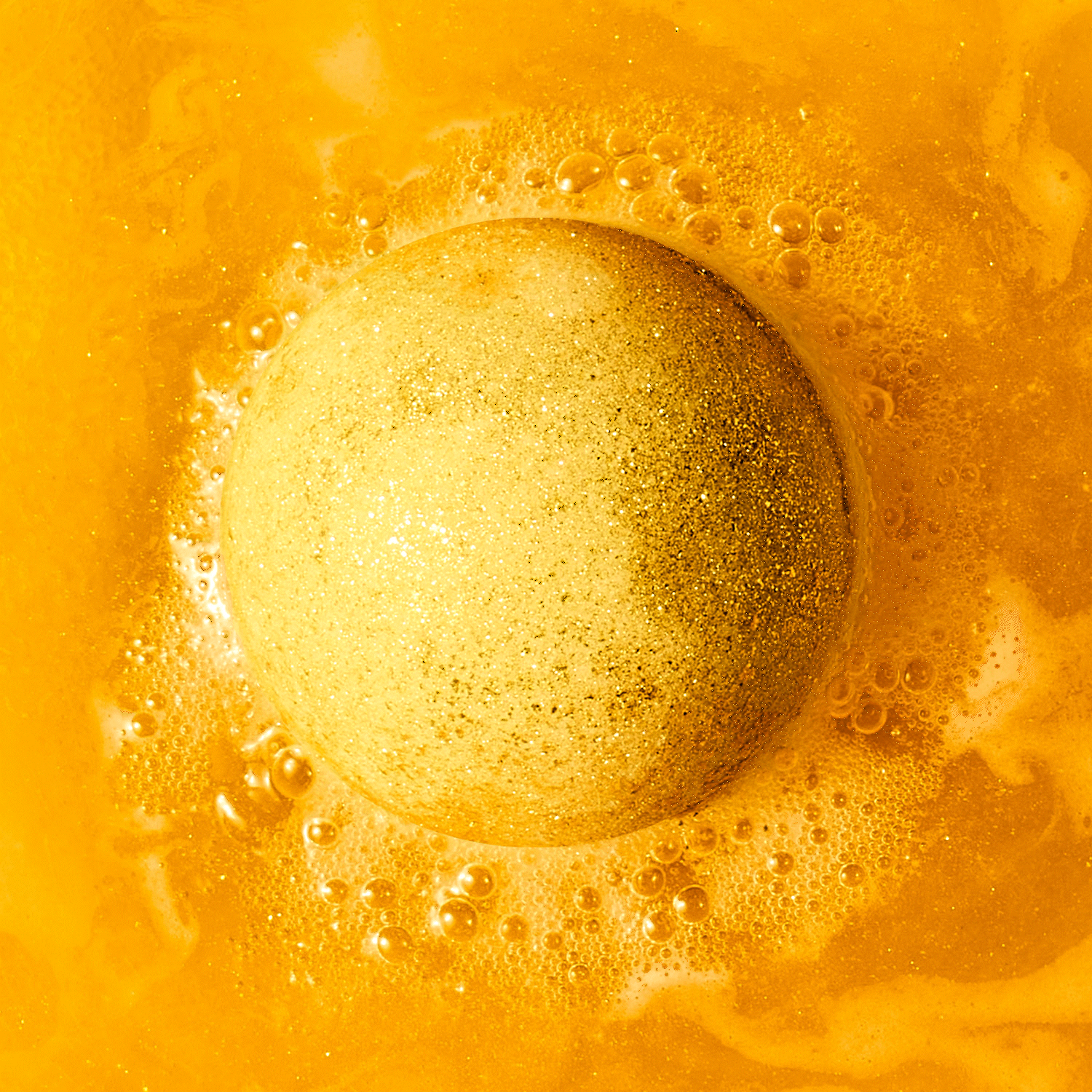 animated gif of gold bath bomb fizzing in water