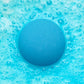 an blue fizzing bath bomb in blue water