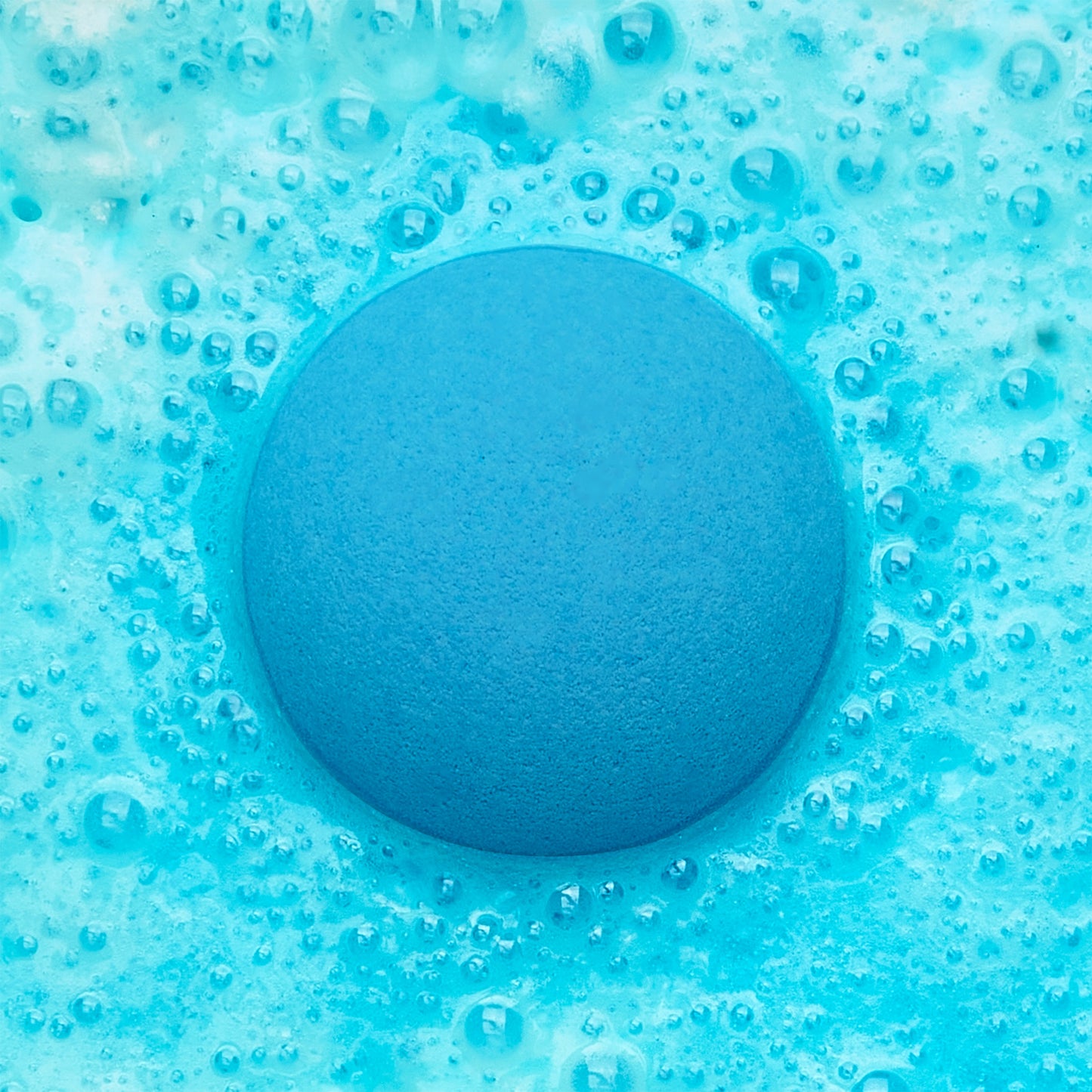 an blue fizzing bath bomb in blue water