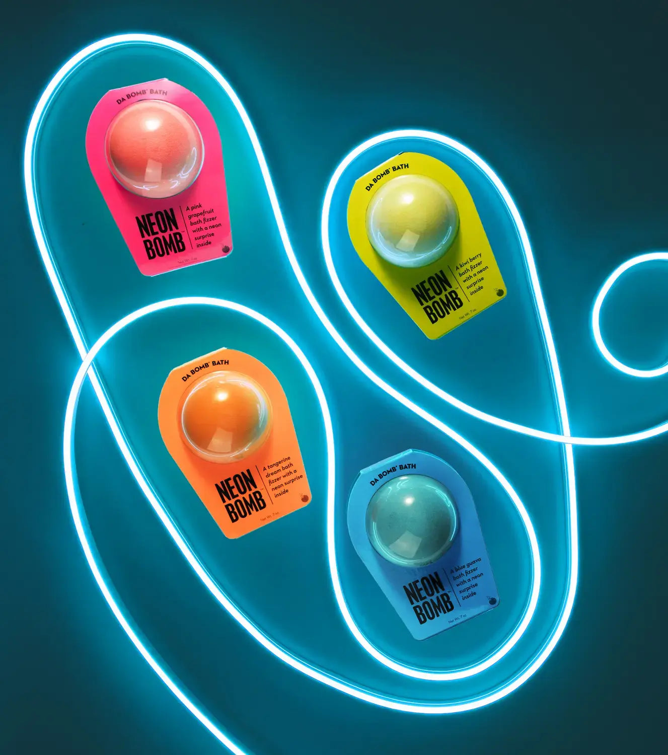 Pink, green, orange, and blue bath bomb with a glowing blue tube interweaving between them