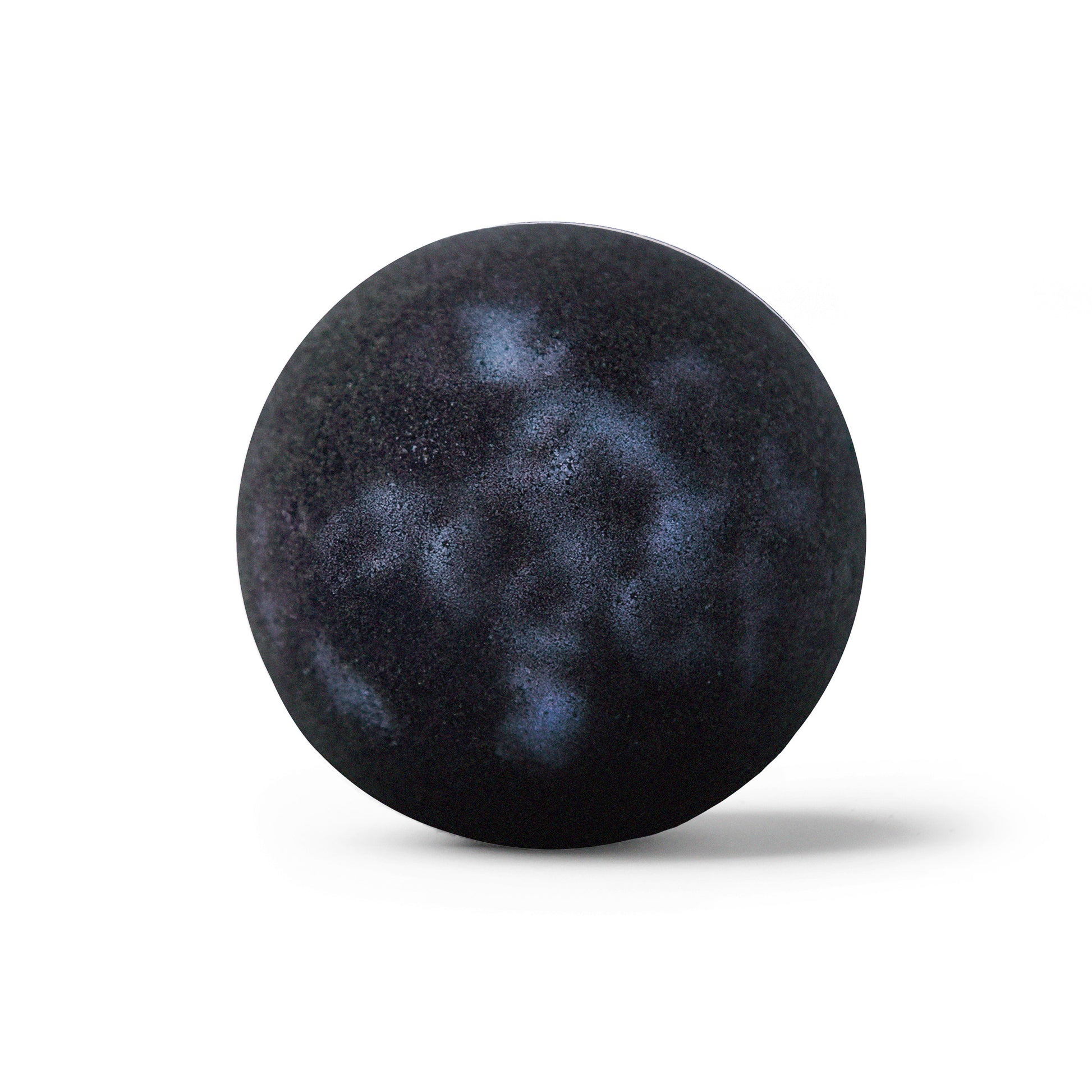 Detail shot of a galaxy bath bomb with shadow