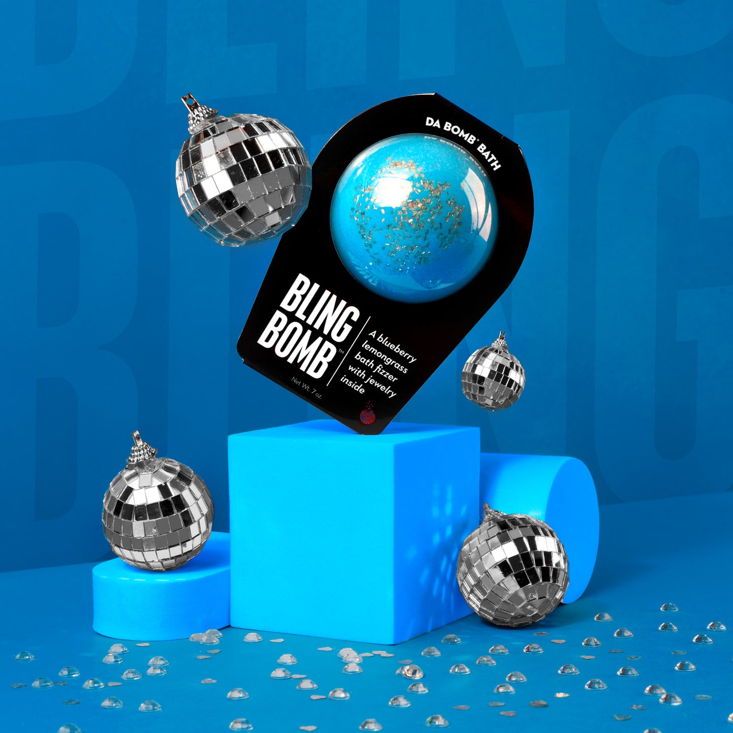 blue bath bomb  product photo on risers with disco balls