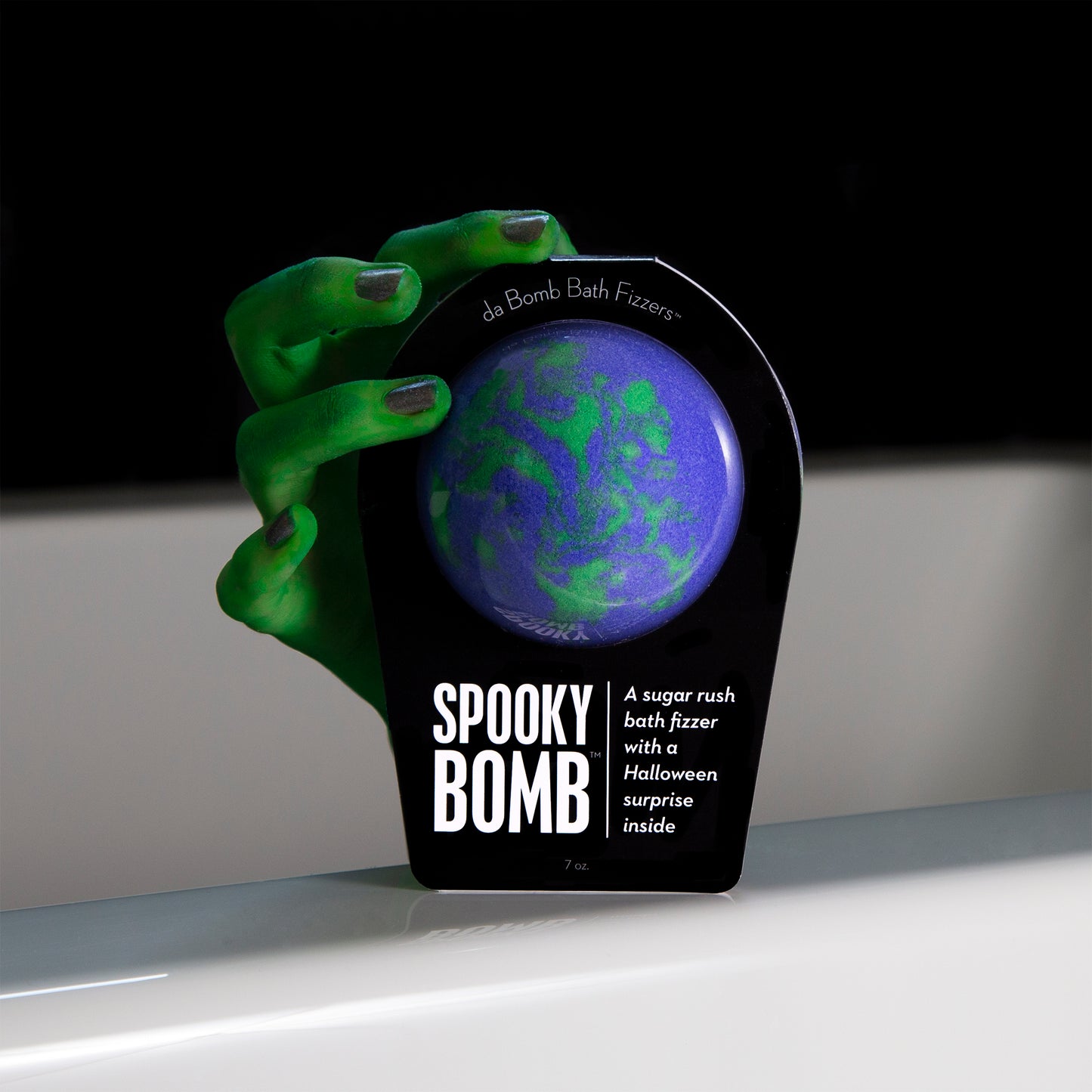 green monster hand holding a da bomb spooky bomb