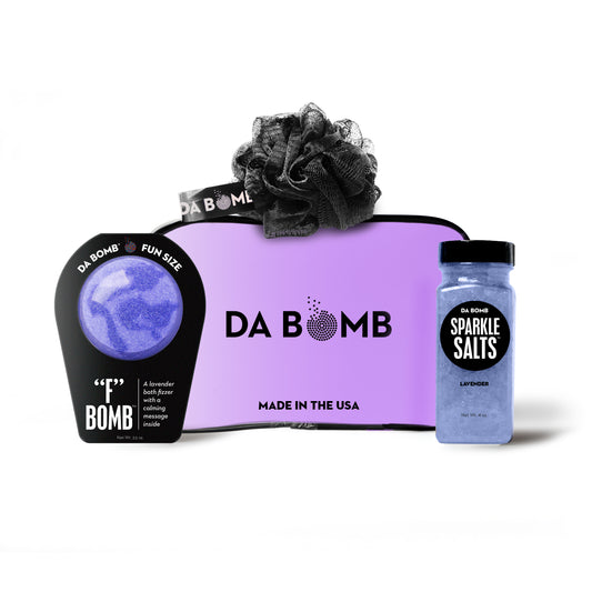 a purple gift set comprised of bath bomb, bath salts and loofah