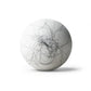 White bath bomb with black hair on white background