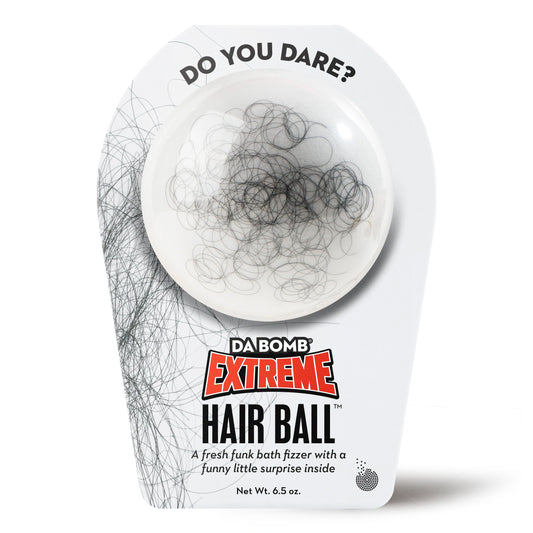 DA BOMB Extreme Hair Ball packaging with white bath bomb covered in black hair on a white background 