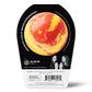 back of a yellow and red bath bomb in black and white packaging