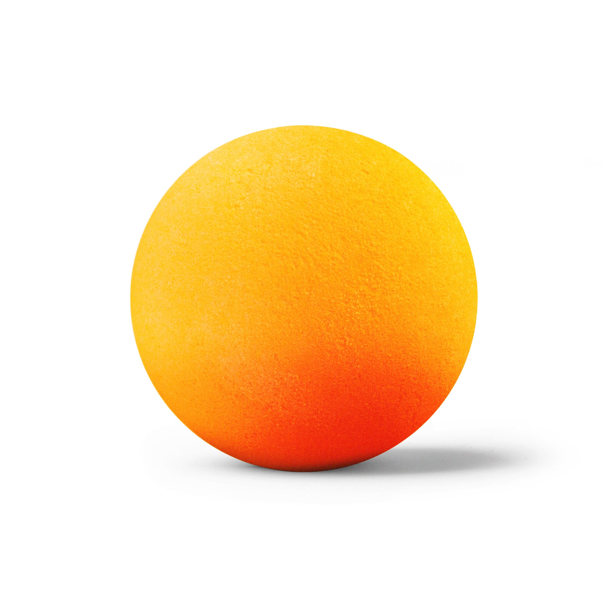 Round orange bath bomb out of packaging on white background scented as sweet orange.