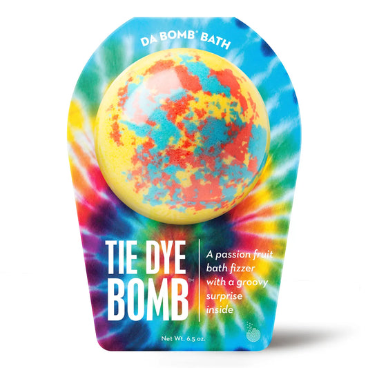 a yellow bath bomb with red and blue dots in tie dye colored packaging