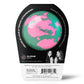 back of a green and pink bath bomb in black packaging 