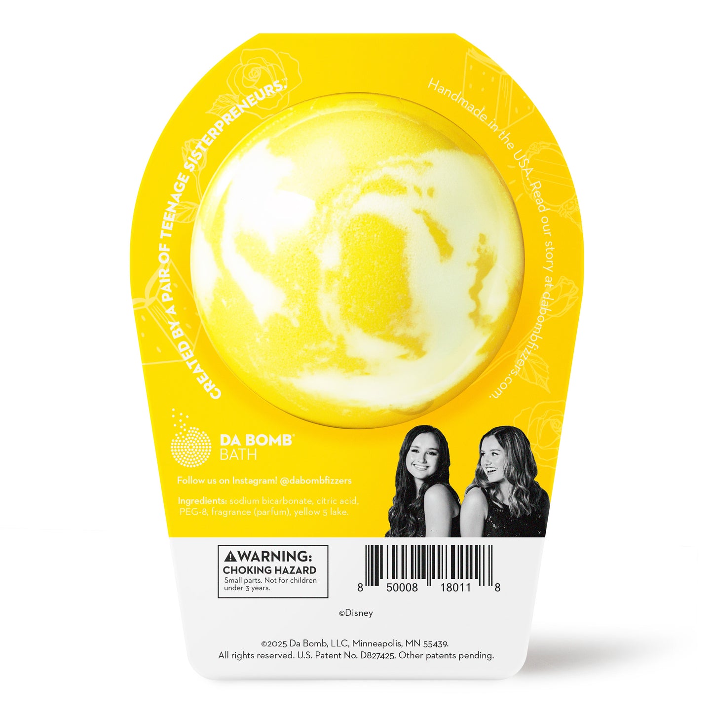 Back of the Belle bath bomb in packaging. Bath bomb is white with yellow swirl on the back.