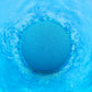 a blue bath bomb fizzing in blue water