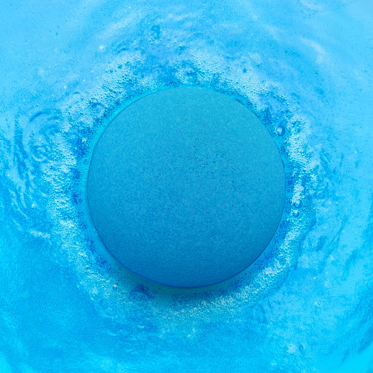 a blue bath bomb fizzing in blue water
