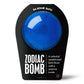 a dark blue bath bomb in black packaging 