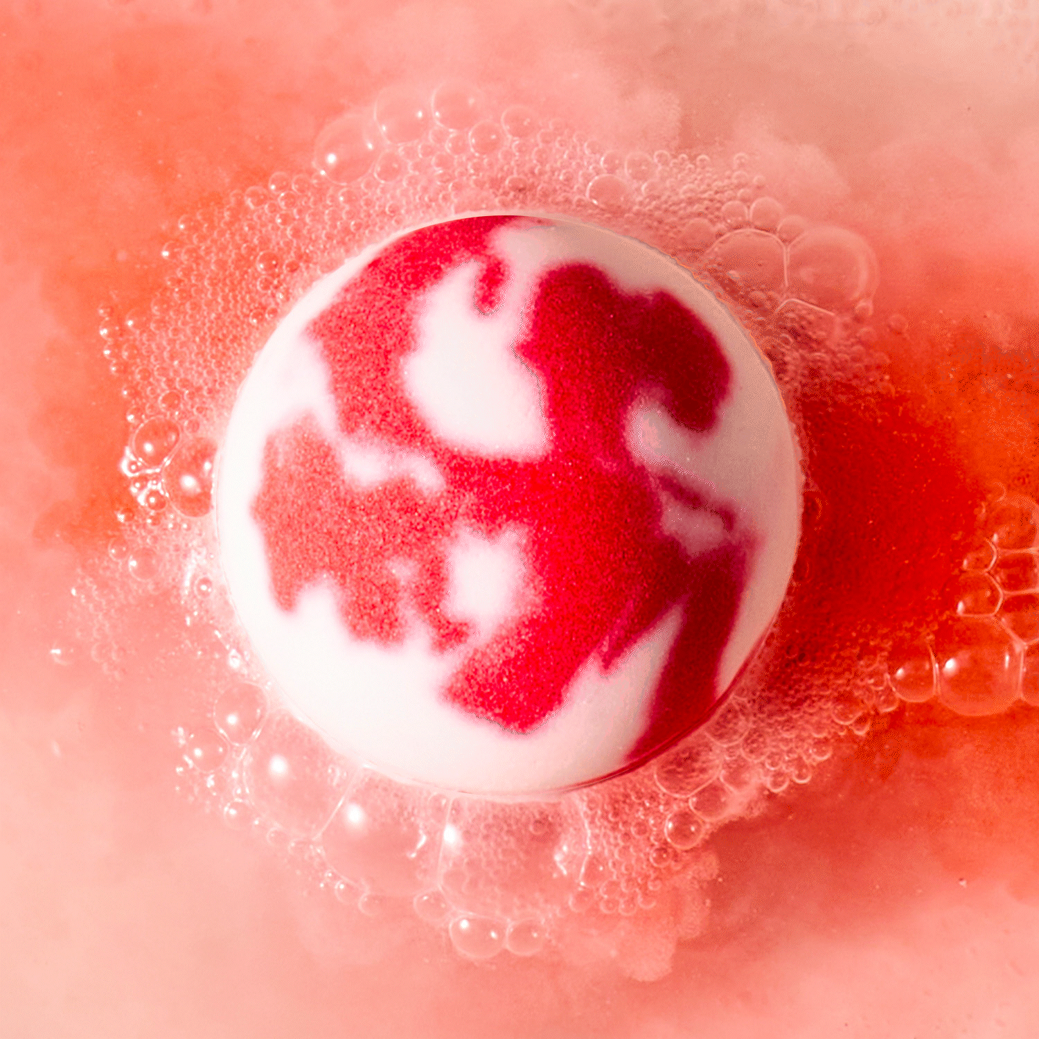 white and red love bath bomb fizzing in water
