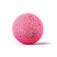 a pink bath bomb with sprinkles