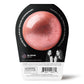 a sparkly pink da bomb bath bomb in black and white packaging