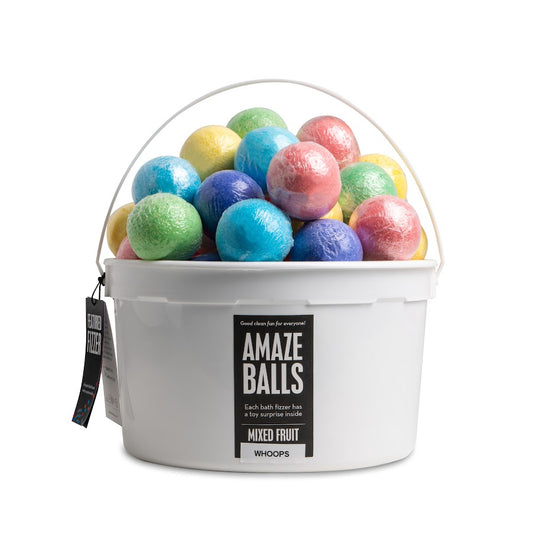 pile of small  multicolored bath bombs in white bucket