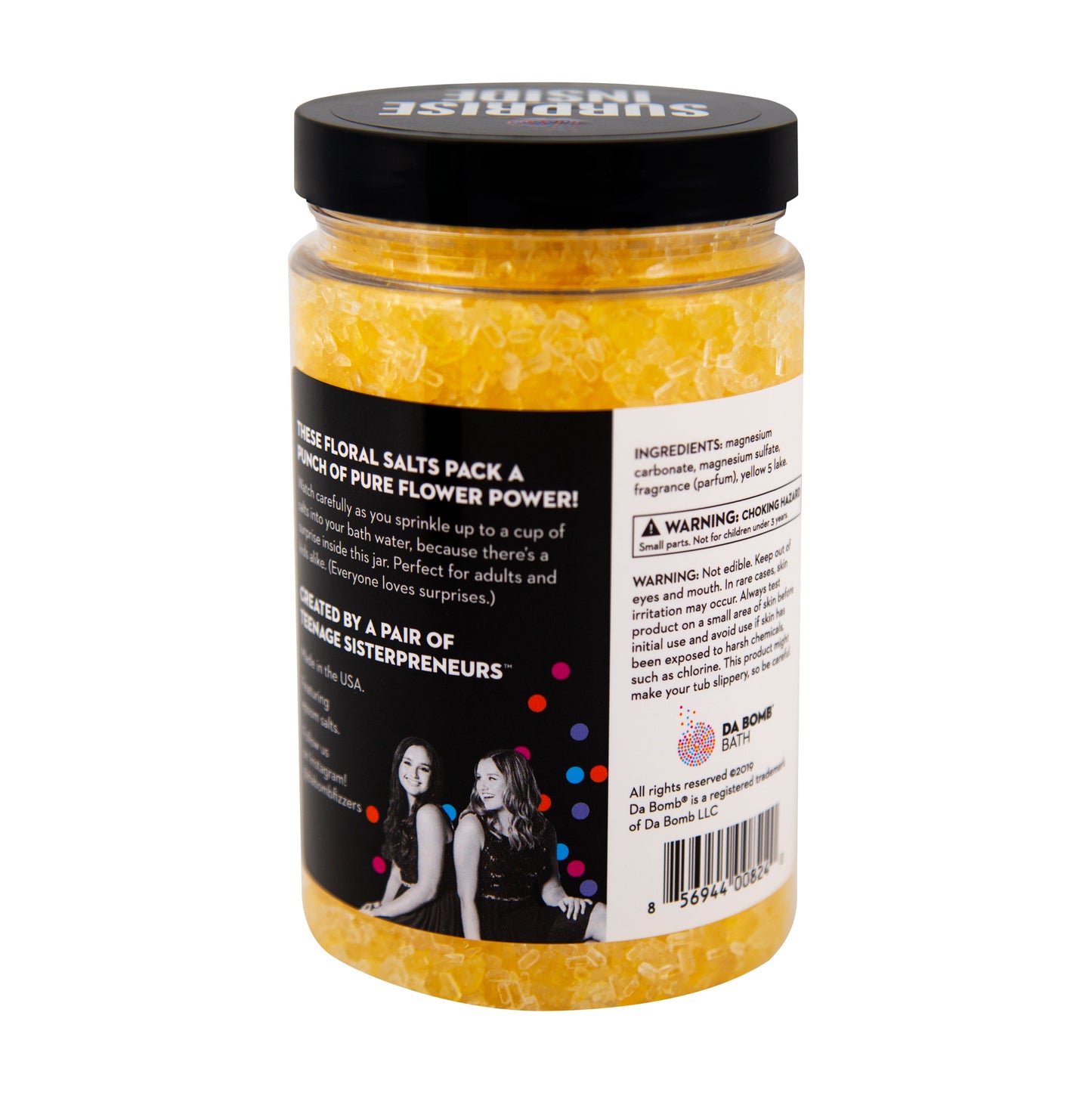 Back of clear plastic jar filled with yellow bath salt that smells like primrose. Contains a fun surprise inside.