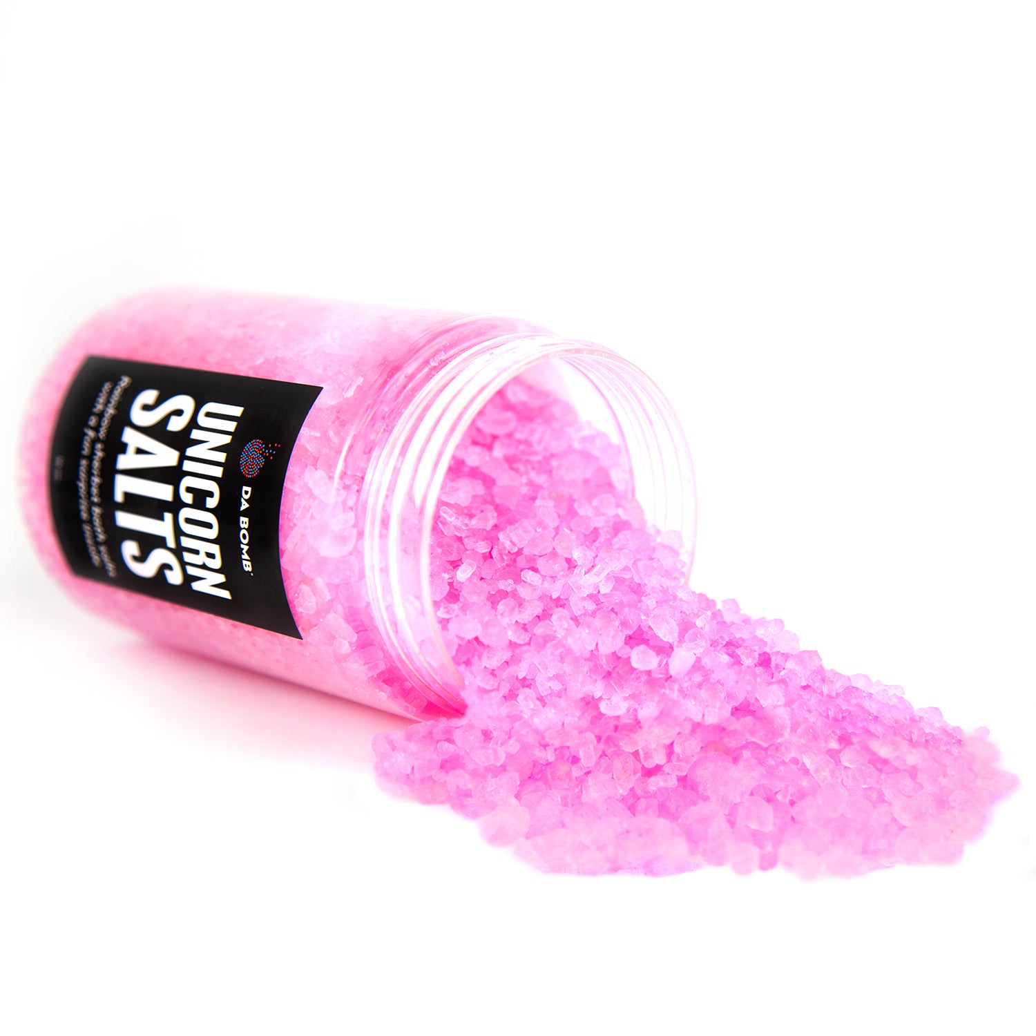 Clear jar with pink bath salts spilling out of it onto a white background.